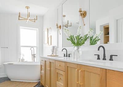 A bathroom with two faucets and a white marble sink and a bathtub made by home renovation contractors in Langley, BC