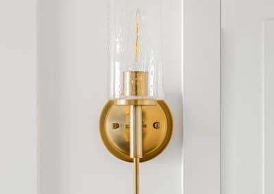 An image of a wall with brass colored lamp with custom additions in Langley, BC