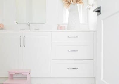 An image of a bathroom with white cabinet made by home renovation contractors in Langley, BC