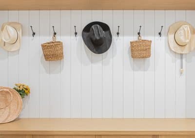 A custom designed wooden shelves and hats on hook with custom additions in Langley, BC