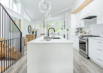 A white accent kitchen with modern industrial kitchen equipment by kitchen renovation contractor in Langley, BC