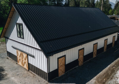 Modern barn with a sleek design and multiple stalls by agricultural building contractors in Langley