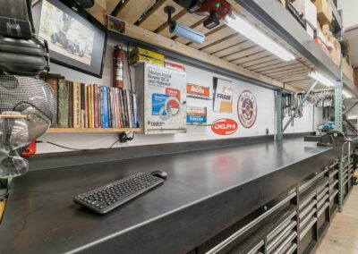 A well-organized workshop with a large workbench, tool cabinets, and shelves stocked with supplies in Langley, BC