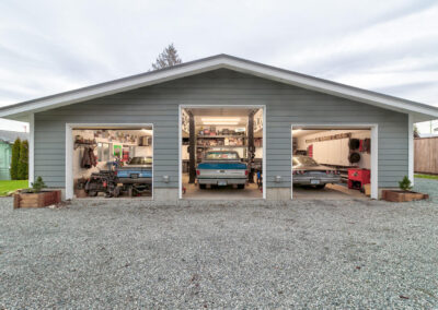 A large, detached garage outbuildings with two car bays and a gravel driveway by Bowline Construction in Langley, BC