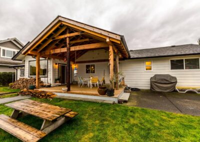 A patio cover with a deck and outdoor furniture.