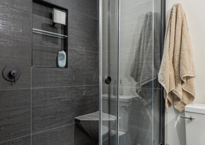 A modern bathroom with a glass-enclosed shower.
