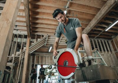 Bowline Construction team staff in a process of cutting wood for pole barn construction in Langley, BC