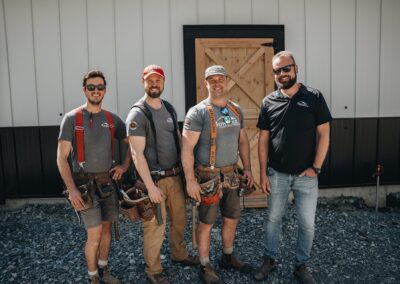 Bowline Construction team members behind a recently constructed pole barn in Langley, BC