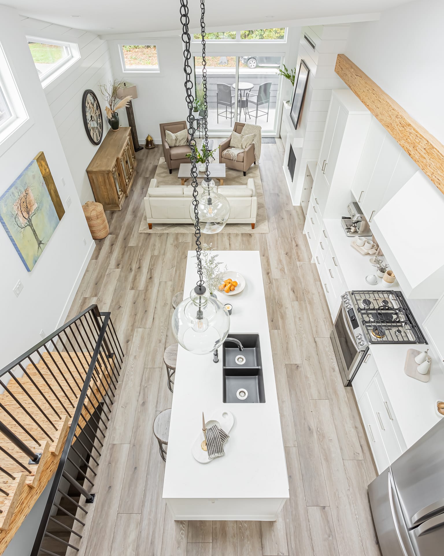 Open-concept living space with a modern kitchen, dining area, and living room by design-build contractors in Langley