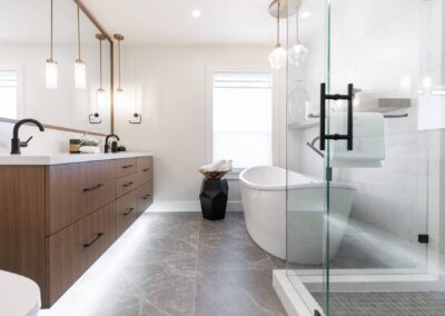 bathroom featuring a freestanding tub, a glass shower, and pendant lights by custom home builder langley, BC