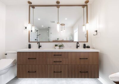 Bathroom featuring a double vanity with a large mirror and pendant lighting by Bowline Construction design-build contractors in Langley, BC