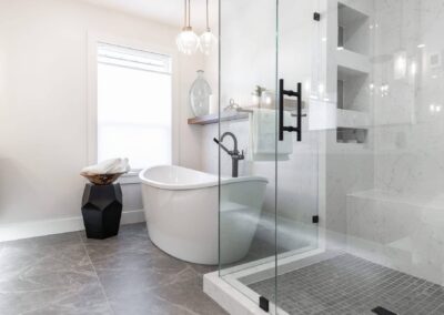 bathroom featuring a freestanding tub, a glass shower, and pendant lights by custom home builder langley, BC