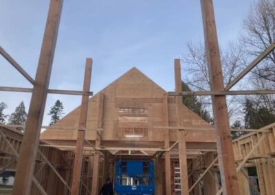 A framed pole barn under construction with a triangular roof and a large open space in the center by Bowline Construction in Langley, BC