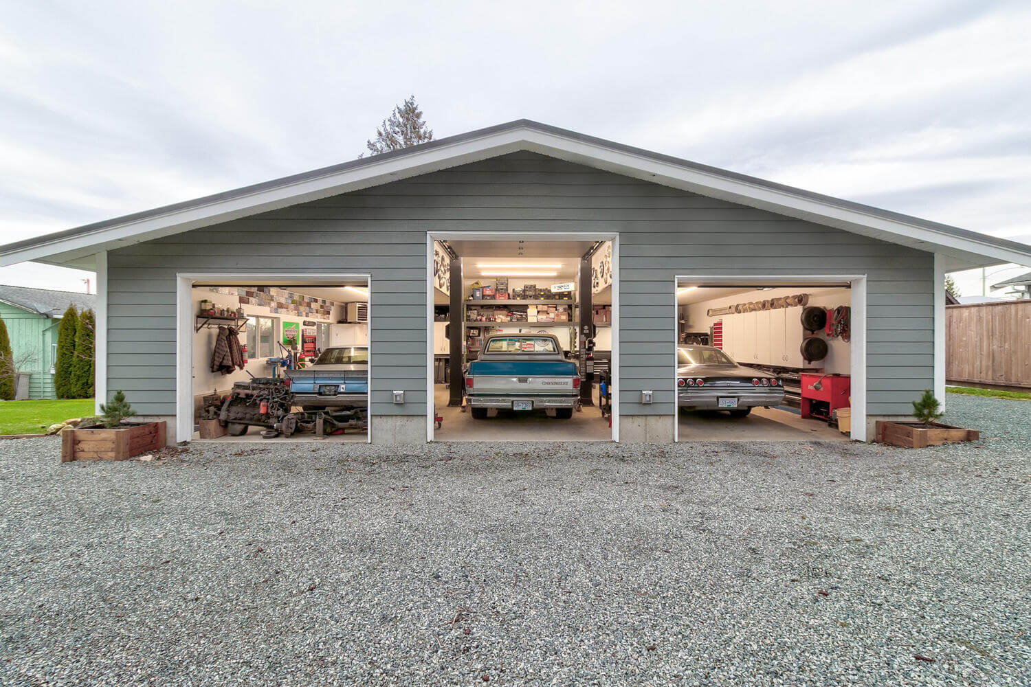 A gray outbuilding with three garage doors in Langley, BC