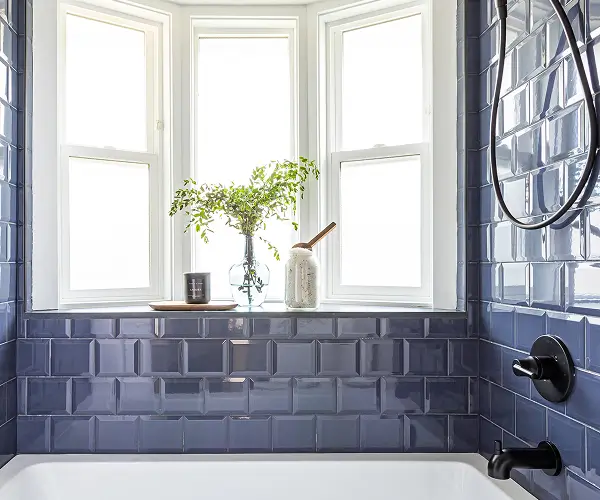 Custom bathroom with blue tile walls and a bay window bathtub by Bowline Construction in Langley, BC