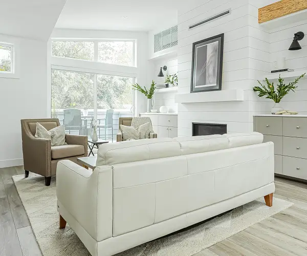 Custom living room featuring fireplace and white modern sofa by Bowline Construction in Langley, BC