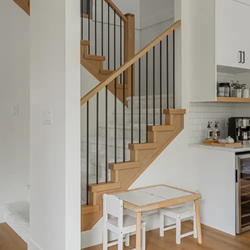 Modern staircase and kitchen interior showcasing home renovations in Langley, BC