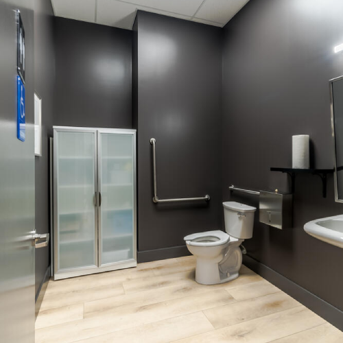 Modern accessible restroom with wood finishes built by Bowline Construction in Langley, BC