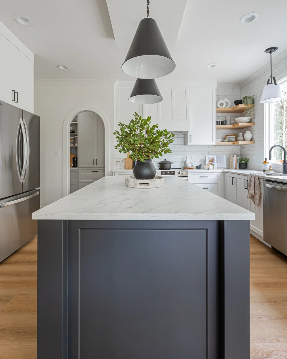 Open-concept kitchen with marble island and stainless steel appliances highlighting home renovations Abbotsford by Bowline Construction in Abbotsford, BC